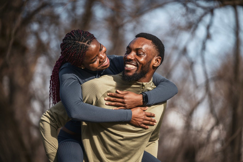 Happy couple smiling with healthy teeth after dental care in Los Angeles