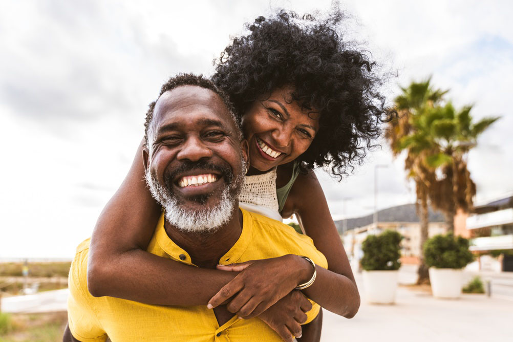 Smiling couple showing healthy smiles after cosmetic dentistry in Los Angeles