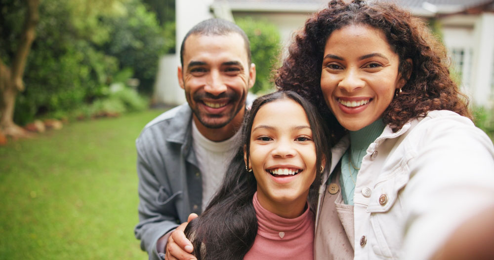 Happy family smiling with healthy smiles after surgical dentistry care in Los Angeles