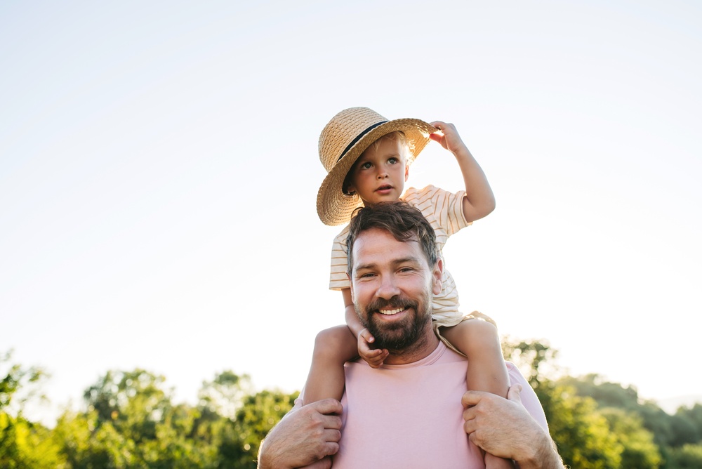Father and child smiling with healthy teeth in Los Angeles family dental care photo