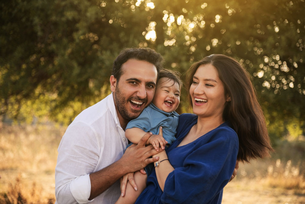 Happy family smiling outdoors after dental care at A Briter Smile Dental Group Los Angeles